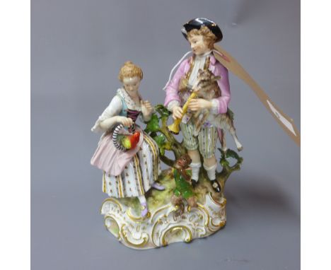 A Meissen porcelain figural group depicting a man and a lady with animals playing musical instruments, including a monkey, a 