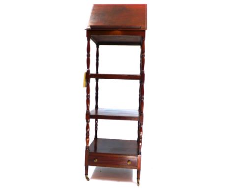 A 19th century mahogany three tier whatnot/music stand with single button drawer and raised on gun barrel supports and castor