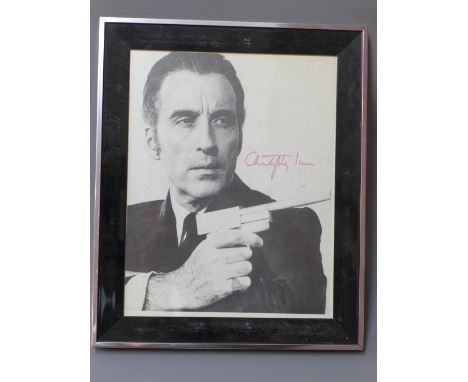 A signed print of Sir Christopher Lee from The Man with the Golden Gun, 30 x 25cm 