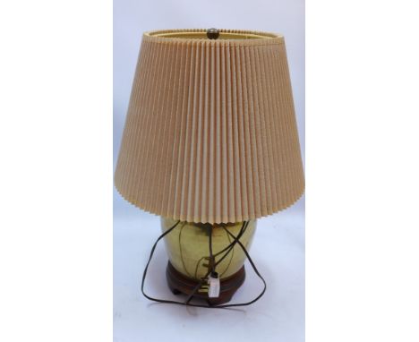 A Chinese style brass table lamp of ovoid form and raised on carved hardwood base, H 37cm 