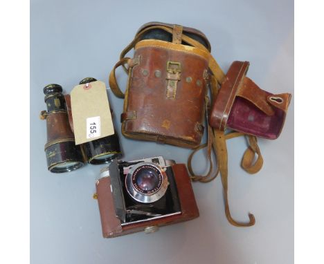 A pair of ebonised binoculars in brown leather case together with a Silida III camera