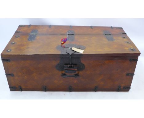 An early 20th century Korean oak iron bound trunk with hinged lid and original key, H 52 x W 140 x D 75cm 