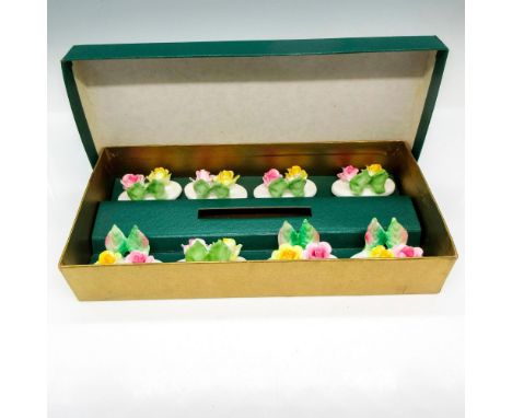 Includes 8 holders decorated with raised flowers and leaves. Crown Staffordshire backstamp. This item has its original box: 5