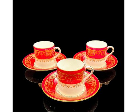 Vintage white bone china with gold scroll and flower design on maroon. Three cups 2.75"L x 2"W x 2.25"H. Three saucers 0.75"H