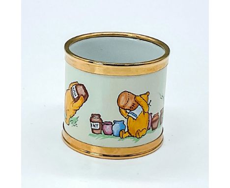 Hand painted napkin ring featuring the popular storybook character Pooh Bear with his head in a jar. Gold rimmed edges. Made 