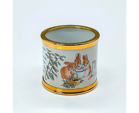 Gold rimmed napkin ring depicts a scene from the Tales of Peter Rabbit. This pieces features a quote from the popular story a