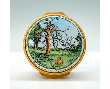 A pale-yellow trinket box depicting Winnie the Pooh walking through the hundred acres woods on the lid. The interior cap read