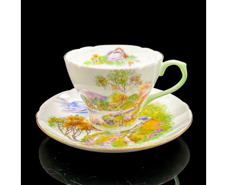 Vintage white bone china with peaceful lakeside scene, gilt rims. New Cambridge shape. Tea cup 4"L x 3.5"W x 2.5"H. Saucer 0.