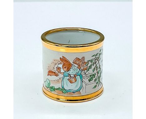 Gold rimmed napkin ring depicts a scene from the Tales of Peter Rabbit. This pieces features a quote from the popular storybo