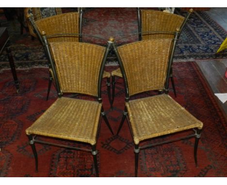 A set of four Contemporary cast metal garden dining chairs, having wicker seat and backrest. 