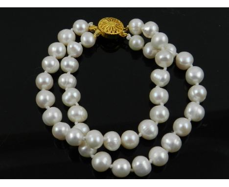 A South Sea pearl necklace, with a 14 carat yellow gold clasp. 