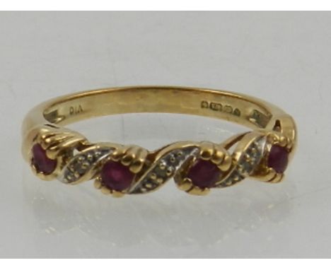 A 9 carat yellow gold, diamond, and ruby ring. 