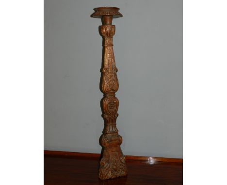 A baroque style carved floor standing pricket candlestick, H. 76cm.