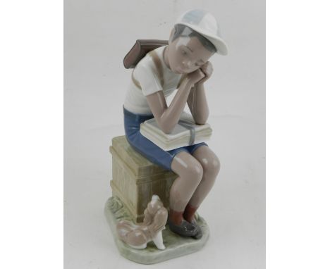 A Lladro figural study of a seated boy with dog. H.22cm