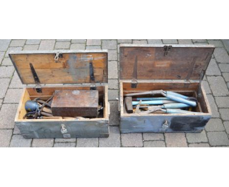 2 wooden trunks containing tools