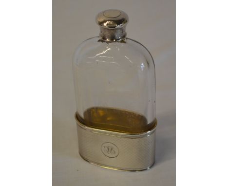 Silver and glass hip flask with removable drinking cup, gilt interior with engine turned exterior and monogrammed cartouche, 