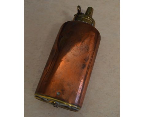 A copper and brass combination powder flask, with single top spout and twin swivel covers to base