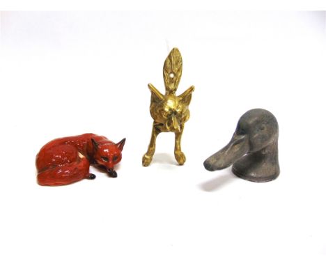 A 'DUCKY' DUCK HEAD BOTTLE OPENER by 'Kirby Beard & Co, Paris'; a Beswick figure of a curled up fox; and a brass Fox Mask Doo