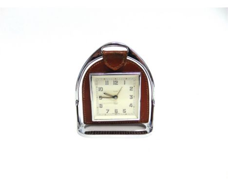 A 'SMITHS' MANTLE CLOCK  in leather mount hung from a stirrup