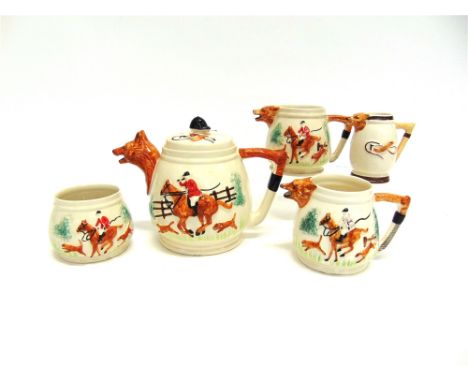 HUNTING TEAWARE with hunting scene decoration in relief, fox mask spouts and whip handles and comprising: teapot, two milk ju