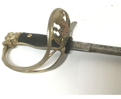 An interesting Prussian court sword with lion head pommel enamelled crest and etched blade. No scabbard.
