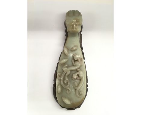 A carved jade sceptre on a hardwood stand, approx length 32cm.