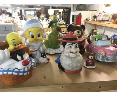 A collection of ceramic novelty storage jars in the form of Warner Brothers cartoon characters and others.