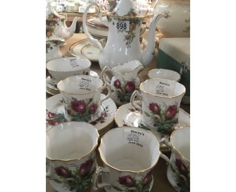 A Royal Albert old English Country rose coffee pot and a Hammersley fine bone China tea set decorated with flowers.