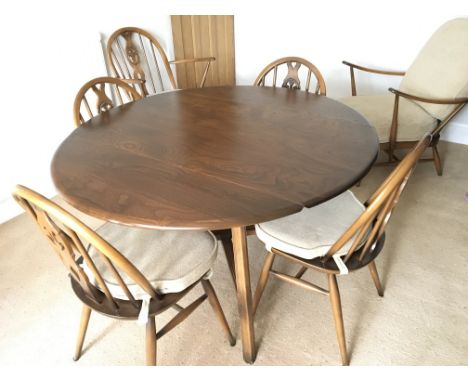 Ercol folding dining table with six chairs with Prince of Wales backs. Table sizes 44 long 48 wide 28 high (inches approx)