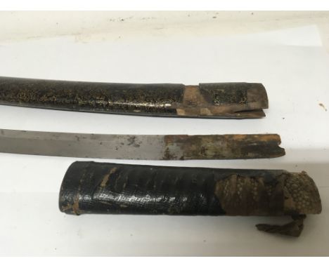 An old Japanese Katana sword with a lacquered scabbard shagreen and leather bound grip. and steel blade.