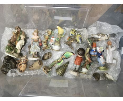A box containing a collection of ceramic ornaments comprising figures of birds, ladies, posies etc.