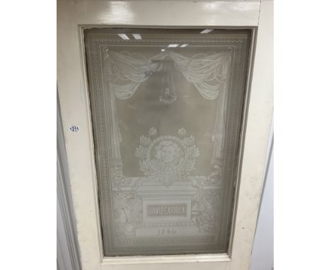 Property of the Robert Browning Settlement, a large white painted internal door inset with an etched glass panel displaying D