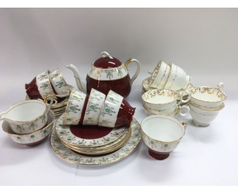 A Windsor tea set in red and white with giltwork decoration together with another service in white and gilt.