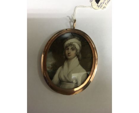 A miniature oval portrait in a unmarked gold frame 8 cm .