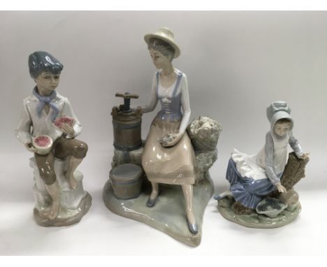 A Nao figure of a young girl and two Lladro style figures (3).