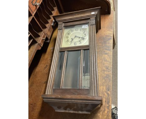 A 1930s oak wall clock