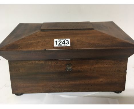 A Mahogany early Victorian tea caddy with a fitted interior.