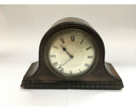 A small oak mantle clock, approx height 13.5cm.