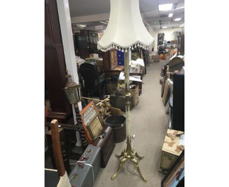 An onyx and gilt metal standard lamp with shade.