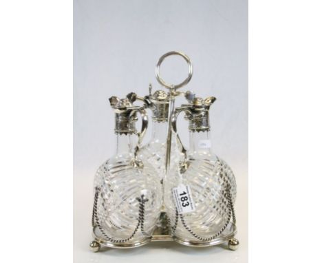 Three white metal mounted cut glass decanters with engraved foliate decoration to collar and hinged lid, scroll handle, shell