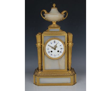 A late 19th century French ormolu and alabaster mantel clock with eight day movement striking on a bell, the circular enamel 