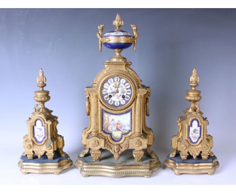 A late 19th century French gilt spelter and porcelain mantel clock garniture, the clock with eight day movement striking on a