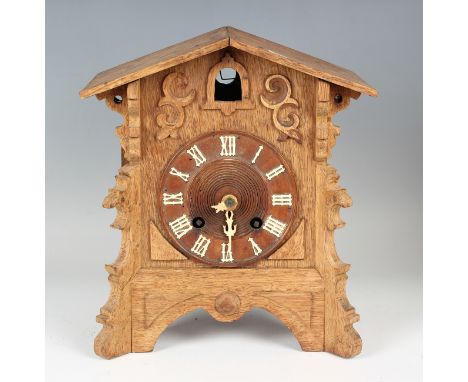 A 19th century Black Forest cuckoo clock with twin fusee movement striking on a gong, the arched case with circular dial, hei