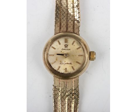 An Omega Ladymatic 9ct gold bracelet wristwatch, the signed gilt dial with baton hour markers, on a mesh link bracelet with f