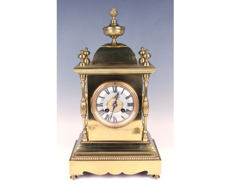 A late 19th century French lacquered brass mantel clock with eight day movement striking on a gong, the silvered chapter ring