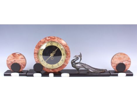 An Art Deco rouge marble, slate and onyx mantel clock garniture, the timepiece with circular dial and surround, on a rectangu