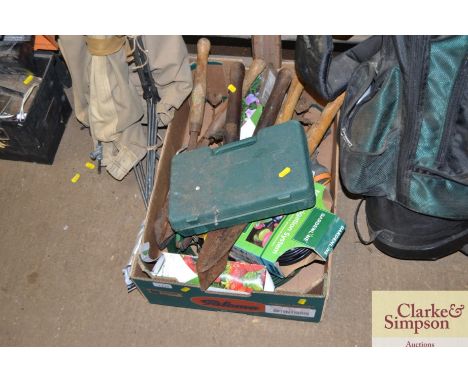A box of various gardening tools and related items