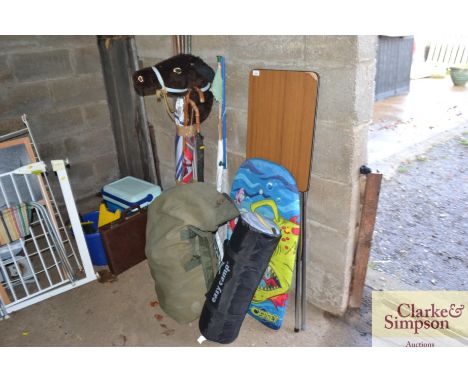 A projector table, a bundle of various gardening tools, keep nets, umbrella's, and camping equipment