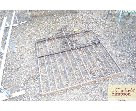 A metal and wrought iron garden gate