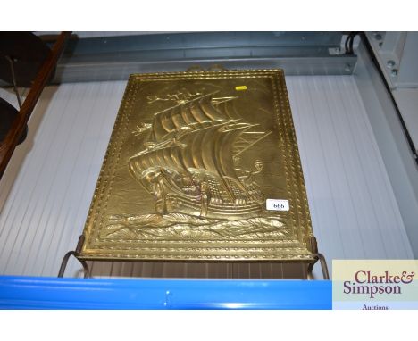 A brass fire screen